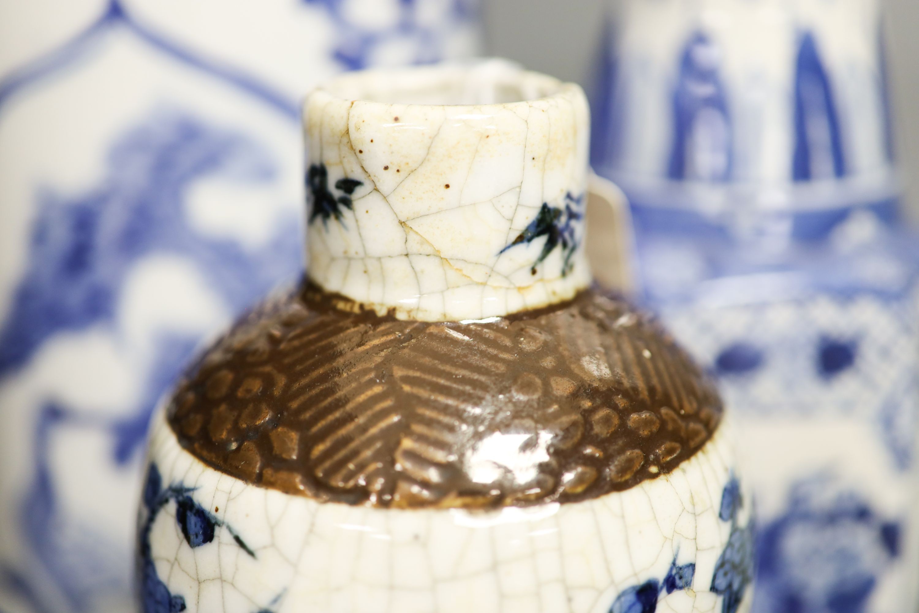 A group of seven Chinese blue and white porcelain vases and jars, 19th/20th century, and three wood stands 27cm